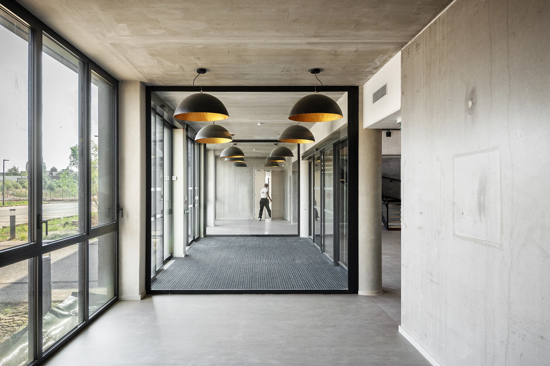 Le nouveau siège social d’un leader français de la maison individuelle affirme les valeurs de la marque à travers une architecture monolithique, moderne et pérenne. Les espaces, organisés autour d’un noyau technique central, offrent souplesse et évolutivité, tandis que les ambiances intérieures et la grande terrasse panoramique renforcent la qualité d’usage.