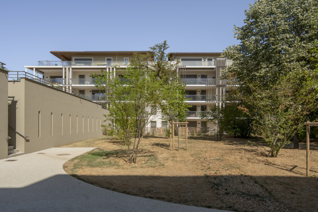 Façade en bardage bois du Domaine Marquise à Valence, ouverte sur le parc paysager et sa végétation.